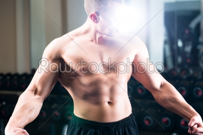 Bodybuilder posing in Gym