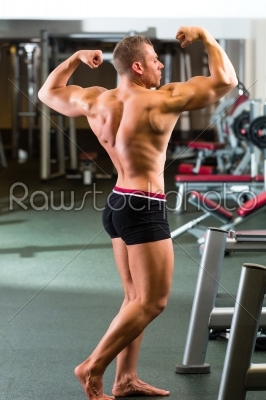 Bodybuilder posing in Gym