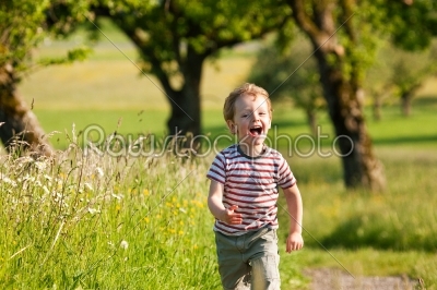 Boy running down a dirtpath