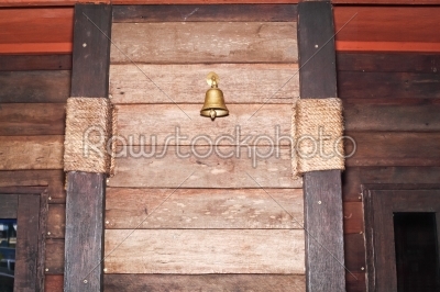 brass bell on old wood panel