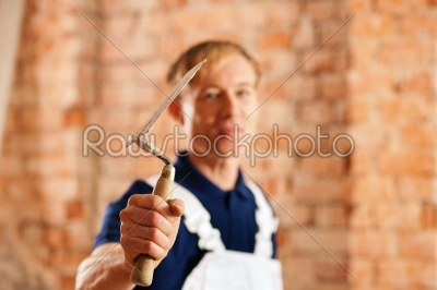 bricklayer with trowel on construction site