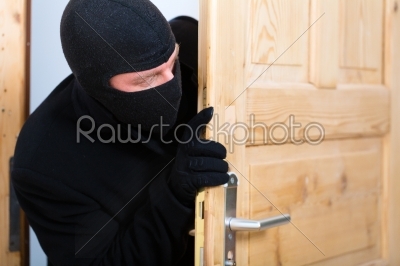 Burglary crime - burglar opening a door
