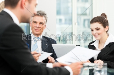 Business people - team meeting in an office