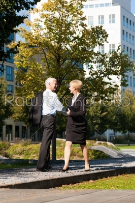 Business people greeting outdoors