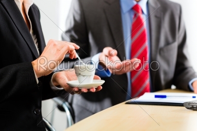 businesspeople in business office drink coffee