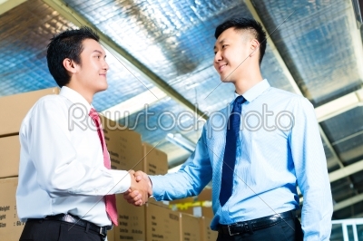 Businesspeople in warehouse have a deal