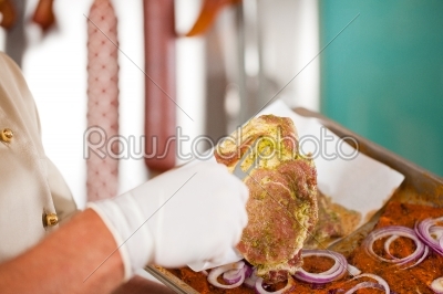 Butcher Holding steak Meat with Fork