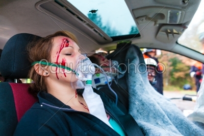 Car accident - Victim in crashed vehicle receiving first aid