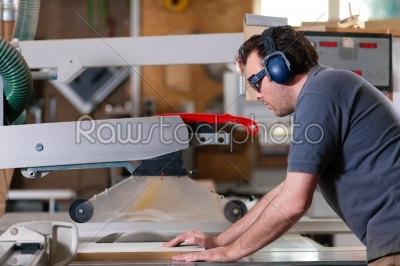 Carpenter using electric saw