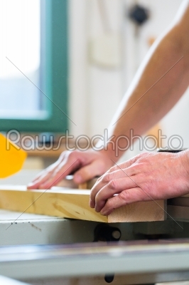 Carpenter using electric saw in carpentry