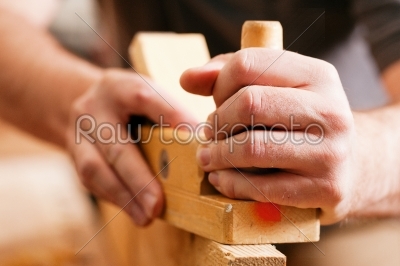 Carpenter with wood planer