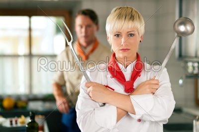 Chef - woman - in restaurant kitchen posing 