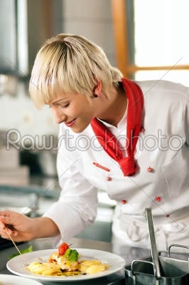 chef in restaurant kitchen cooking