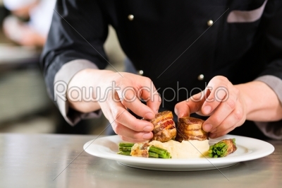 Chef in restaurant kitchen preparing food