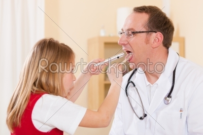 Child is examining throat of her doctor