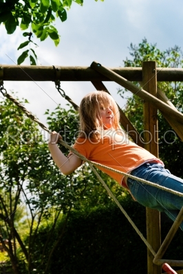 Child on a swing in garden