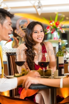 Chinese business people dining in elegant restaurant