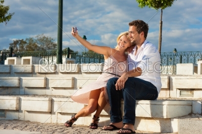 City tourism - couple in vacation on a bench