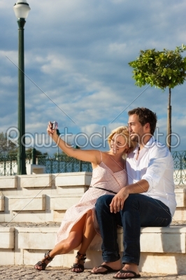 City tourism - couple in vacation on a bench