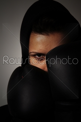 closeup  portrait of girl with black boxing gloves  