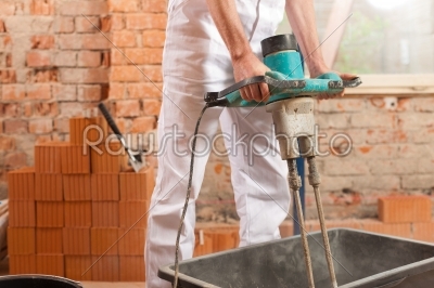 Construction worker mixing concrete