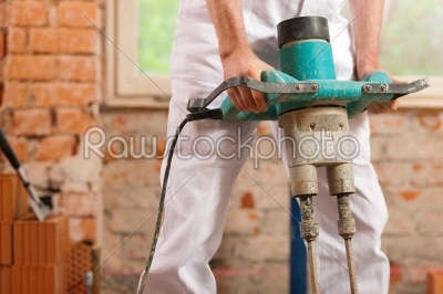 Construction worker mixing concrete