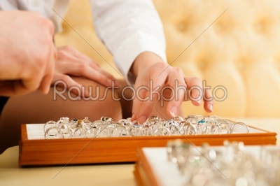 Couple choosing a ring at the jeweller