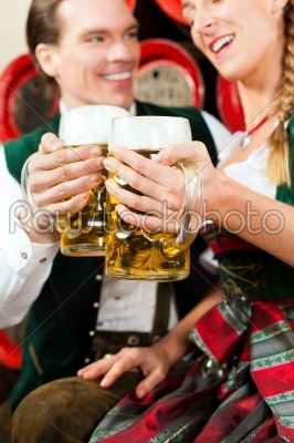 Couple drinking beer in brewery