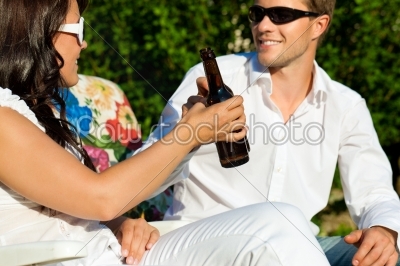 Couple drinking beer in summer