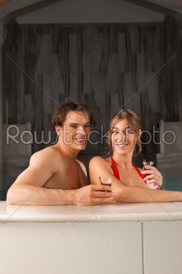 Couple drinking tea in swimming pool