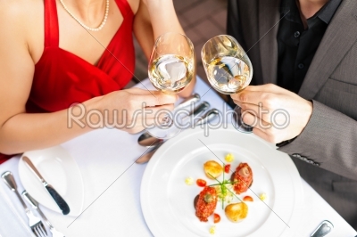 Couple eating and drinking in very good restaurant