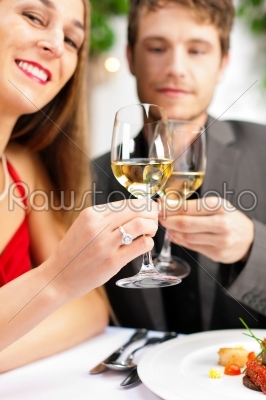 Couple eating and drinking in very good restaurant