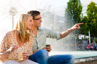 Couple enjoying take away coffee in a break