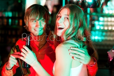 Couple having drinks in bar or club