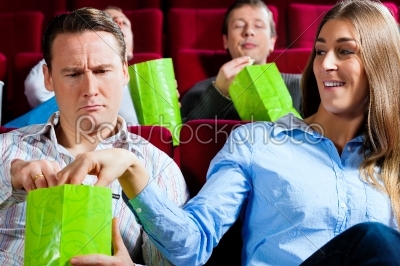 Couple in cinema with popcorn