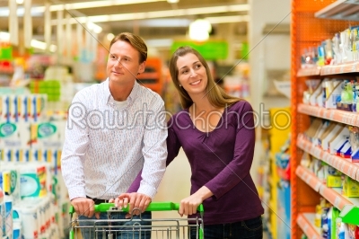 couple in supermarket with shopping cart