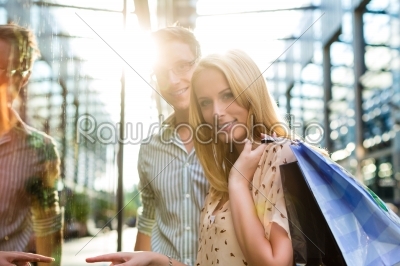 Couple while shopping and spending money