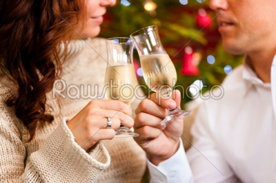 Couple with champagne on Christmas Eve