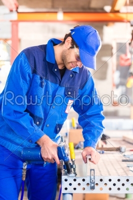 Craftsman rivet metal in workshop