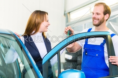 customer and car mechanic in auto workshop