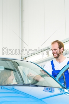 customer and car mechanic in workshop