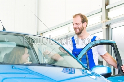 customer and car mechanic in workshop