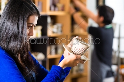Customer holding a Cup in a gift shop