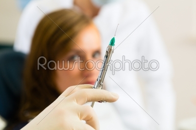 dentist holding a syringe