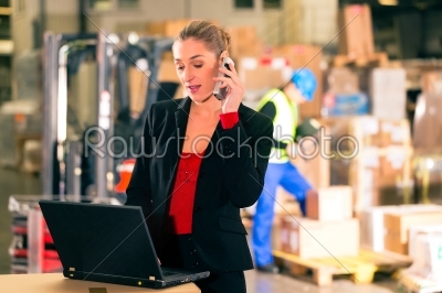 dispatcher using phone at warehouse of forwarding