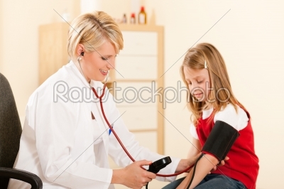 Doctor measuring blood pressure of child