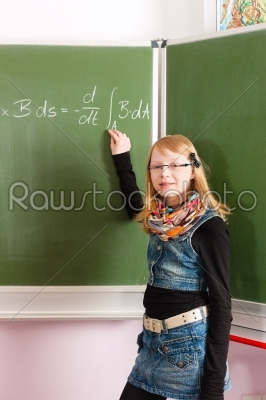 Education - Child or pupil at blackboard in school