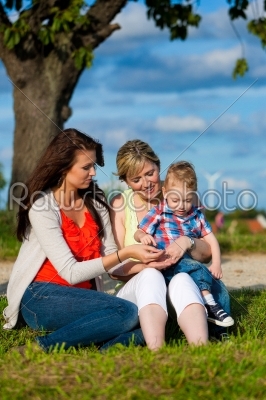 Family - Grandmother, mother and child in garden