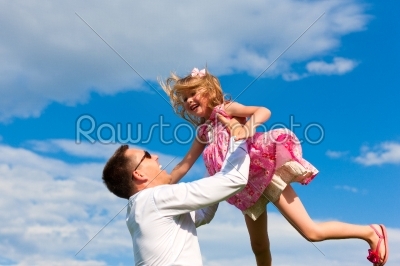 Family affairs - father and daughter playing in summer