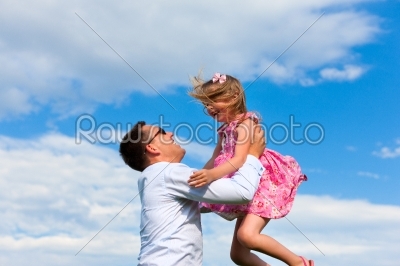 Family affairs - father and daughter playing in summer